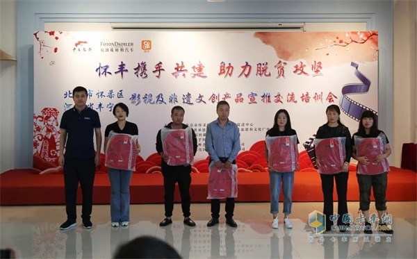福田戴姆勒汽車營銷公司副總經(jīng)理、華北分公司總經(jīng)理劉剛向重卡司機家屬代表捐贈學習文具